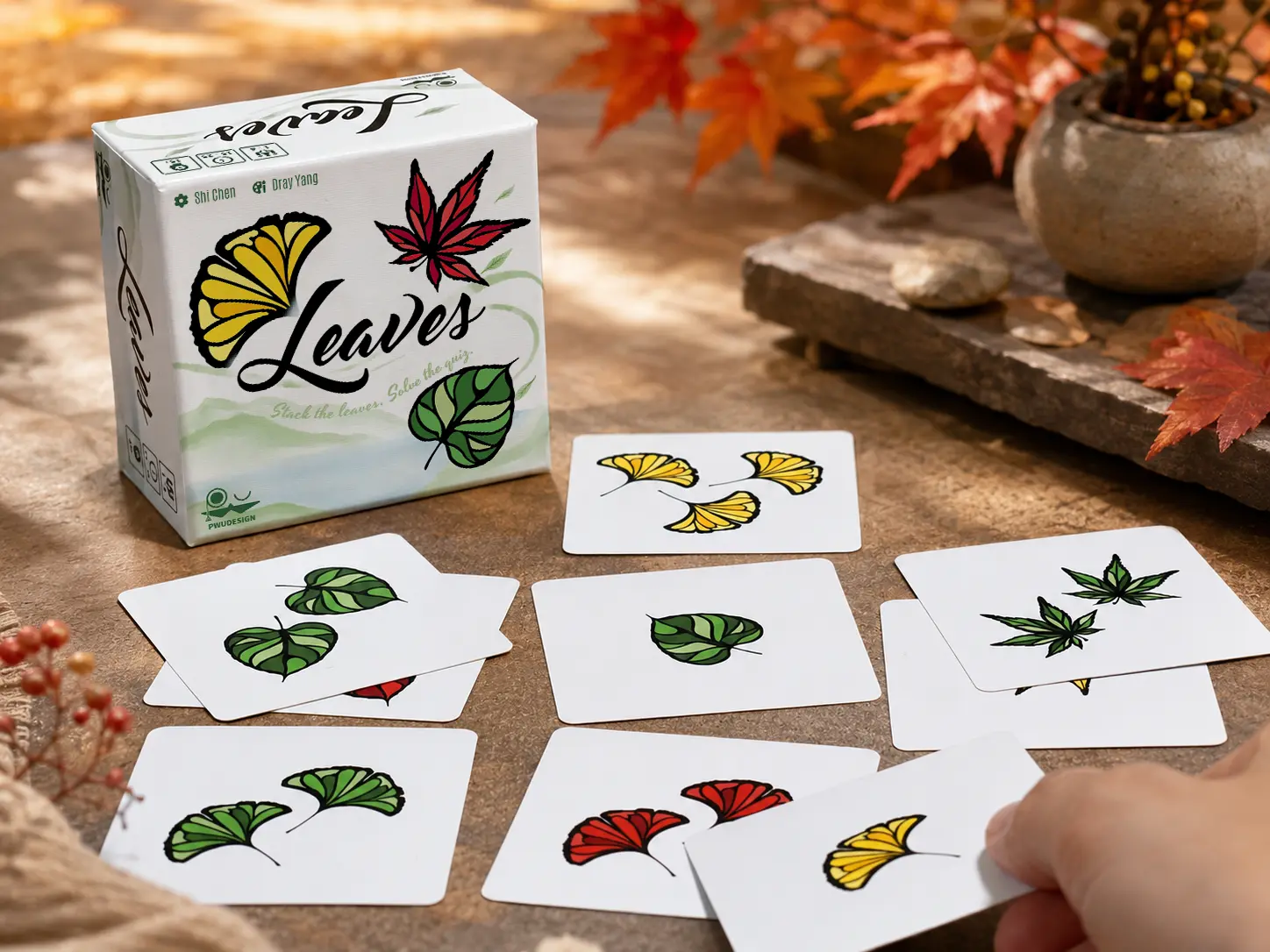 A player solving Leaves among autumn foliage and the game box